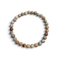 The Voyager men’s bracelet with 6mm Imperial Jasper gemstone beads in dusty cornflower blue, tan, cream, and brown tones on a white background.