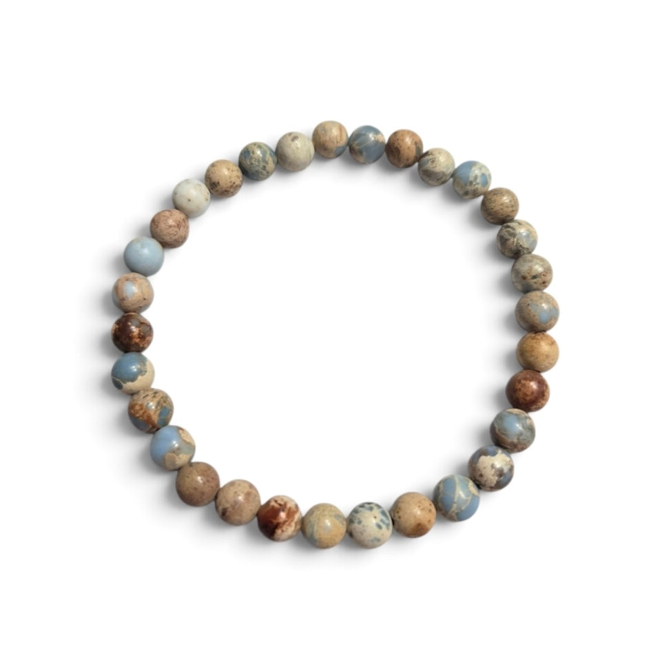 The Voyager men’s bracelet with 6mm Imperial Jasper gemstone beads in dusty cornflower blue, tan, cream, and brown tones on a white background.